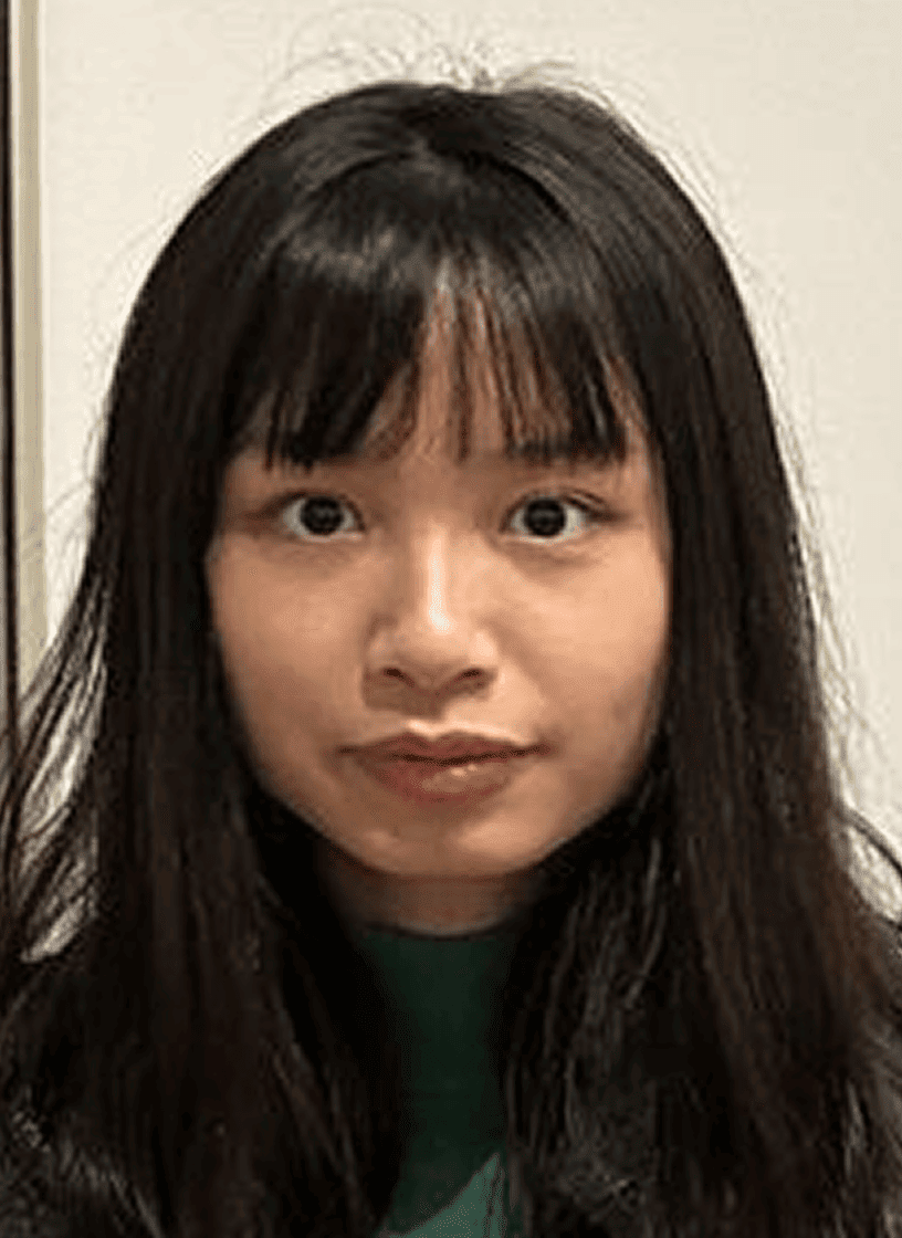 Julie Tran A young woman with long dark hair and bangs, wearing a green top, looks directly at the camera with a neutral expression.